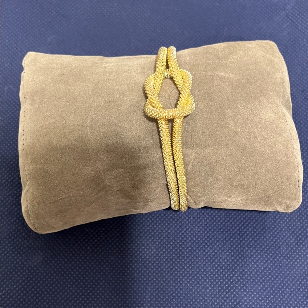 Gold Knot Bracelet on Tan Suede Pillow